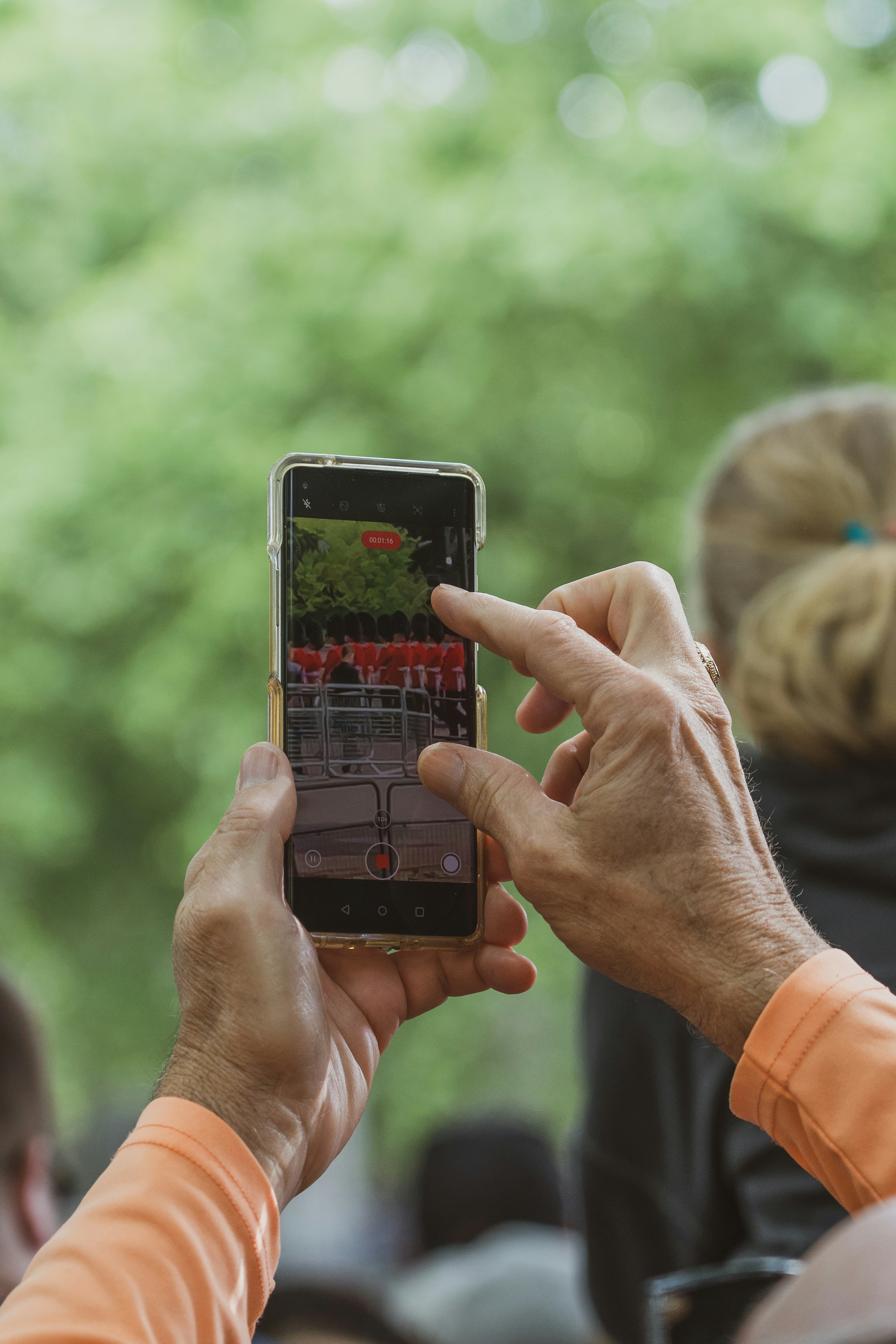 An older adult capturing a moment on their smartphone